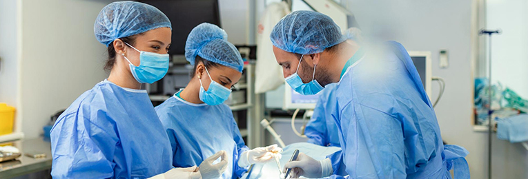 3 doctors seen doing a surgery at a operation theater